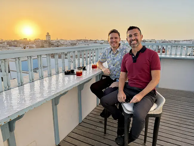 Andy & Trai enjoying sunset negroni cocktails at L'Heure Bleue