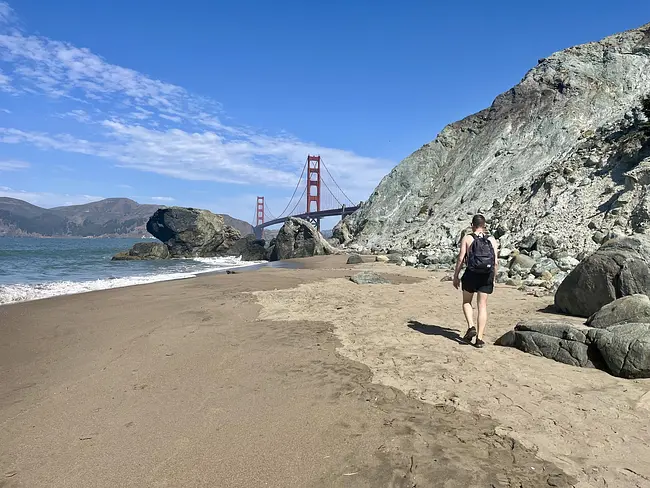 Andy walking along Marshall's Beach towards the Golden Gate Bridge