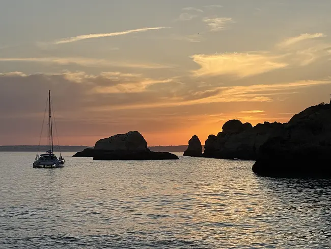 Sunset with sailboat at Praia João de Arens