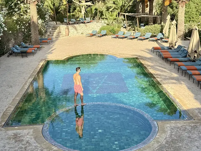 Trai walking the pool at Le Jardin des Douars