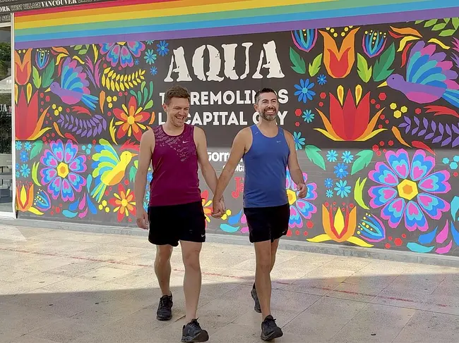 Andy & Trai walking holding hands at La Nogalera Gay Complex