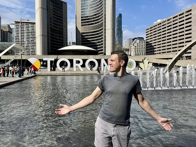 Andy in front of Toronto sign