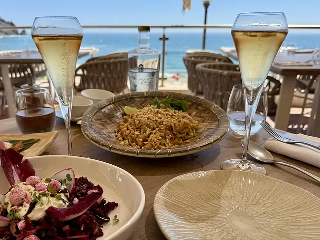 Table spread and bubbles at Zazu Beach Club overlooking the beach
