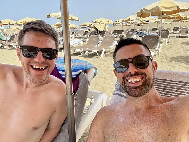 Andy & Trai in loungers at Maspalomas Gay Nude Beach